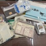「机の上に並べられた切手、未使用テレホンカード、官製はがきの写真。伊勢佐木モール本店で切手・テレカ・はがきをまとめて買取している様子を表したイメージ。」