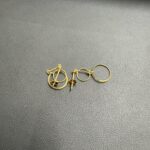 黒いトレーの上に小さなゴールドのフープピアスとポストピアスがいくつか並んでいる写真。蒔田店で金ピアスを査定している様子。